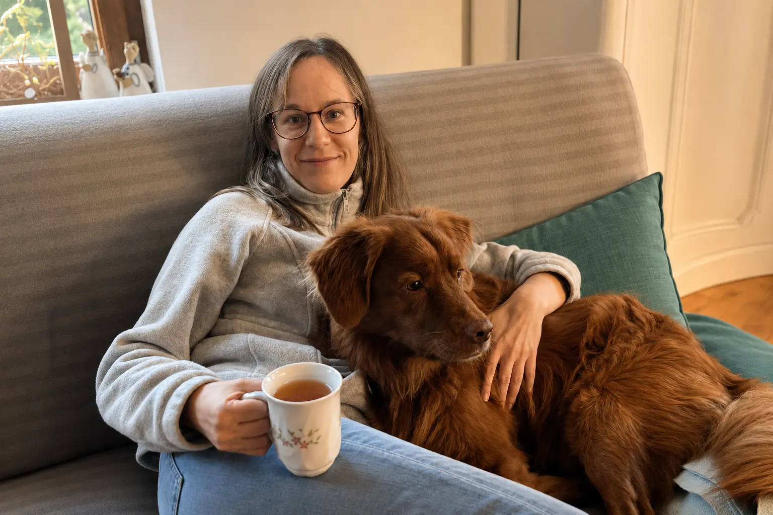 Marlena relaxing at home with herbal tea and the family dog